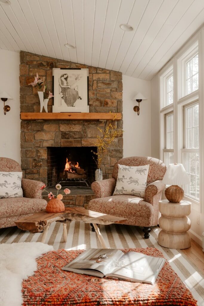 Cozy living room with stone fireplace and comfortable chairs.