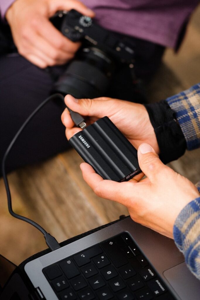 hands holding a black device